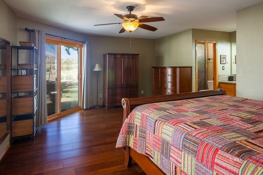 400 Dominy Road Lone Pine, CA 93545 - Photo 11 of 33 a bedroom with a bed and a chandelier