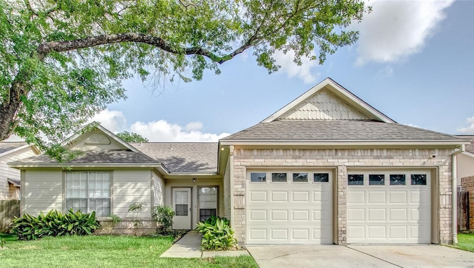 3207 Georgia Pine Drive Spring, TX 77373 - Photo 1 of 29 a front view of a house with a yard and potted plants