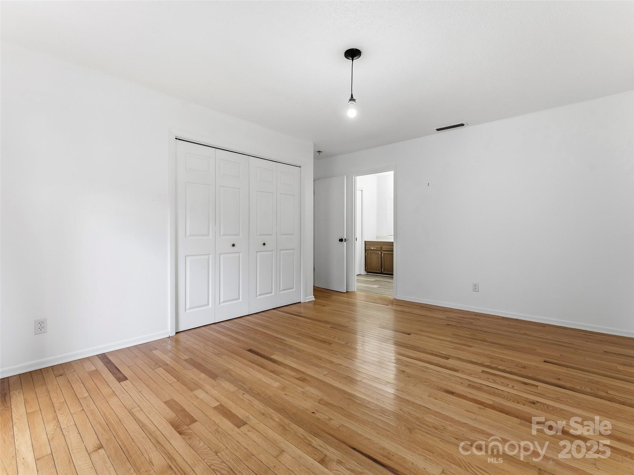 27 Spring Valley Road Pisgah Forest, NC 28768 - Photo 23 of 37 a view of an empty room with wooden floor