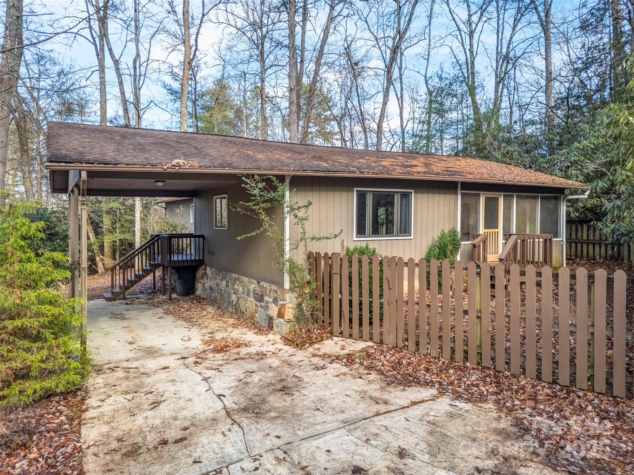 27 Spring Valley Road Pisgah Forest, NC 28768 - Photo 3 of 37 a view of house with backyard and chairs