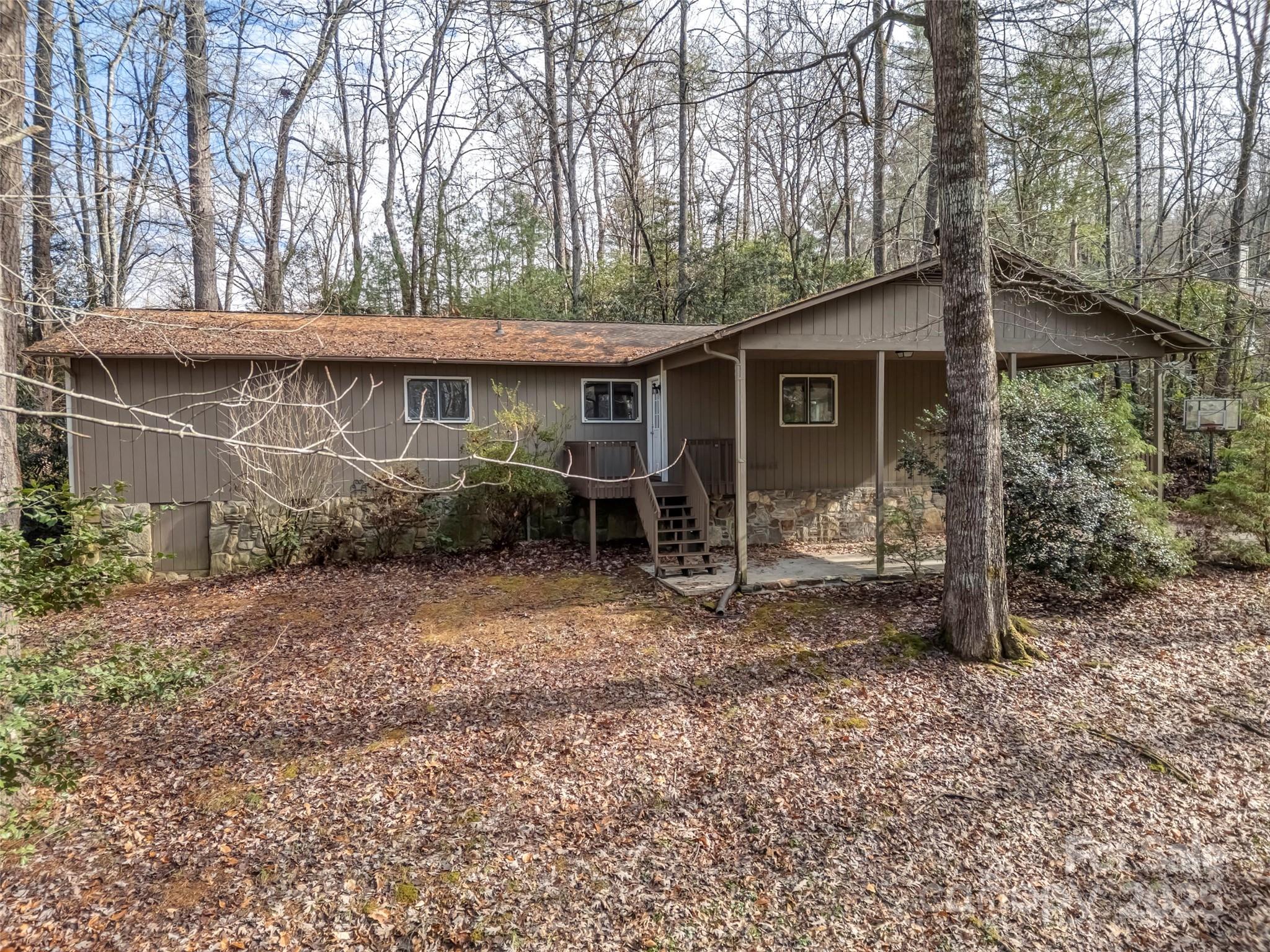 27 Spring Valley Road Pisgah Forest, NC 28768 - Photo 34 of 37 a view of a house with a yard and large trees