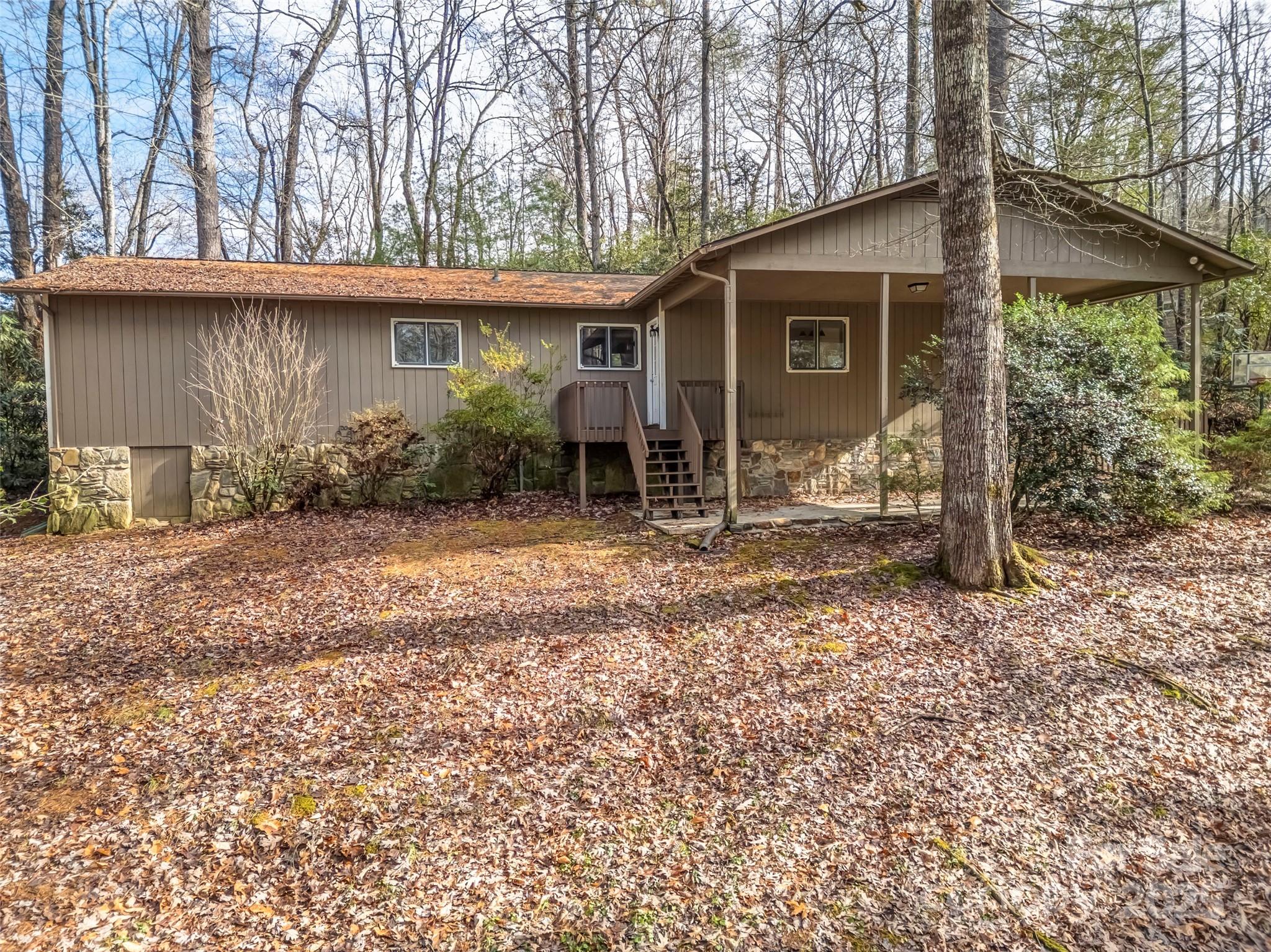 27 Spring Valley Road Pisgah Forest, NC 28768 - Photo 4 of 37 a backyard of a house with yard and outdoor seating