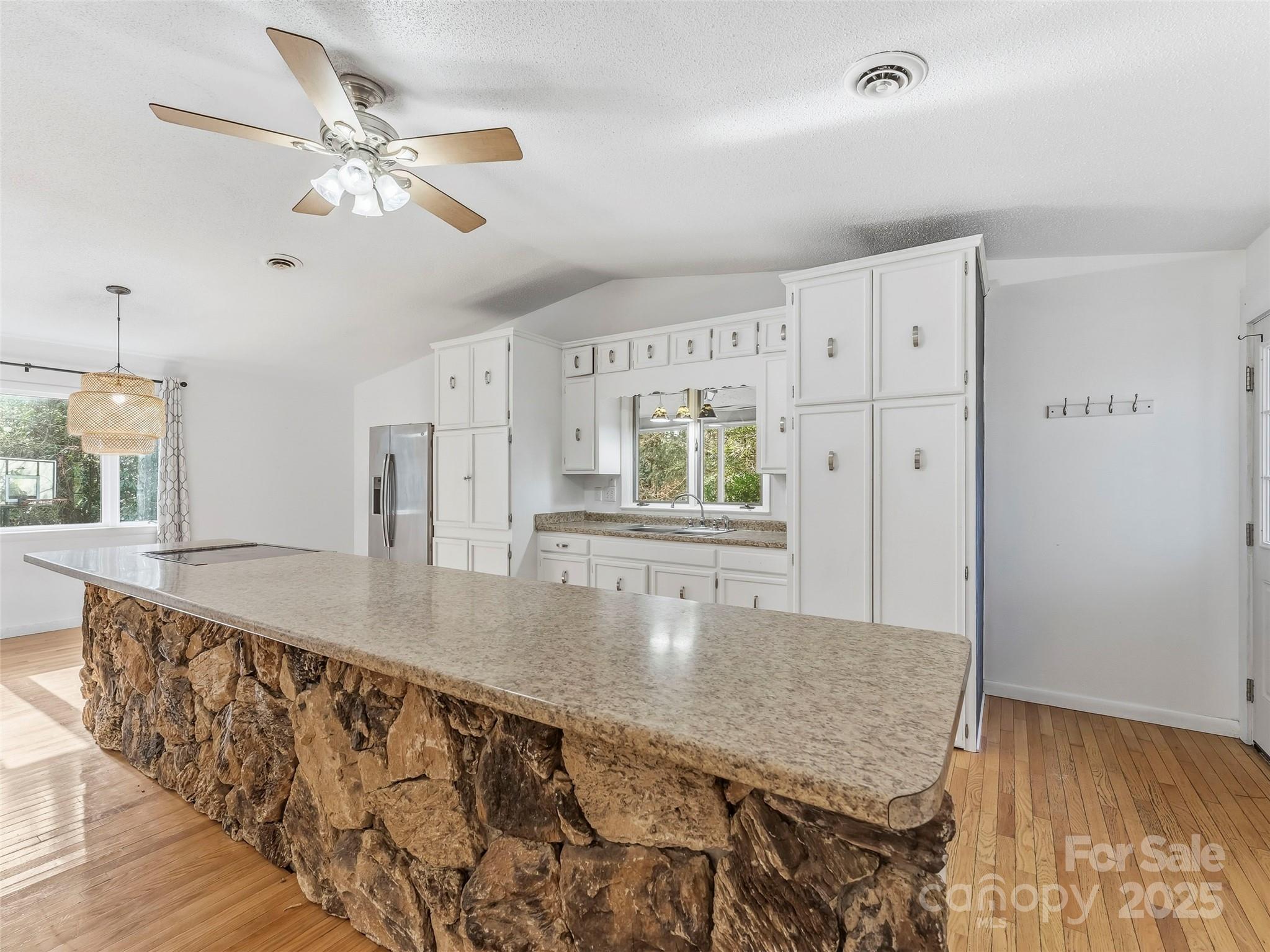 27 Spring Valley Road Pisgah Forest, NC 28768 - Photo 6 of 37 a kitchen with stainless steel appliances granite countertop a sink dishwasher and cabinets with wooden floor