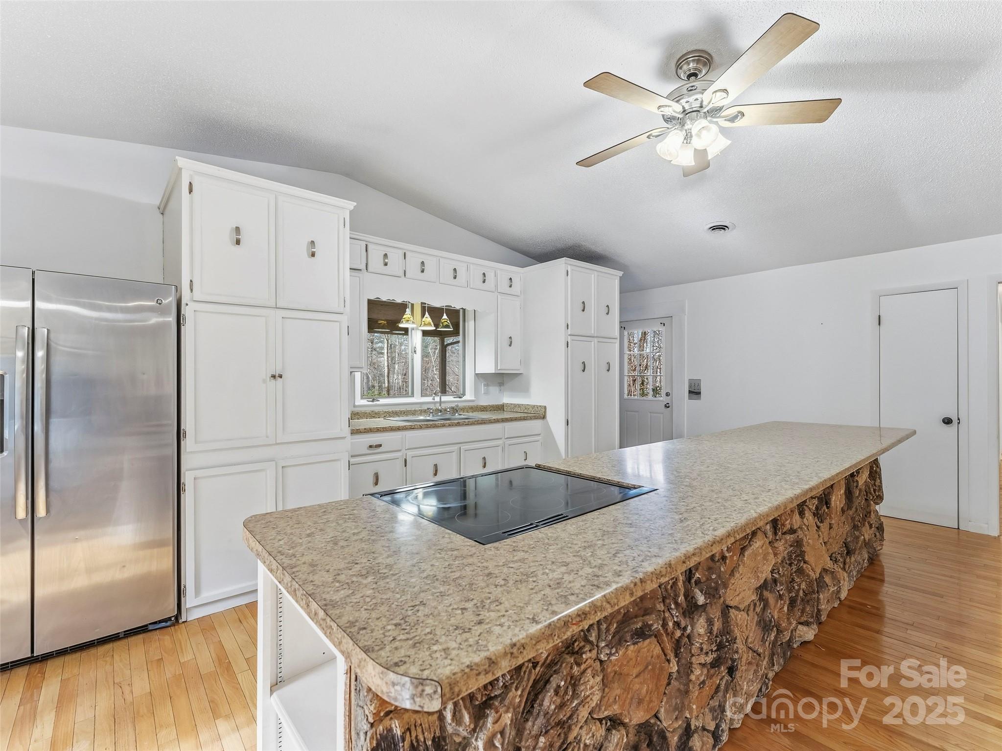 27 Spring Valley Road Pisgah Forest, NC 28768 - Photo 7 of 37 a kitchen with stainless steel appliances granite countertop a sink a refrigerator and a granite counter tops