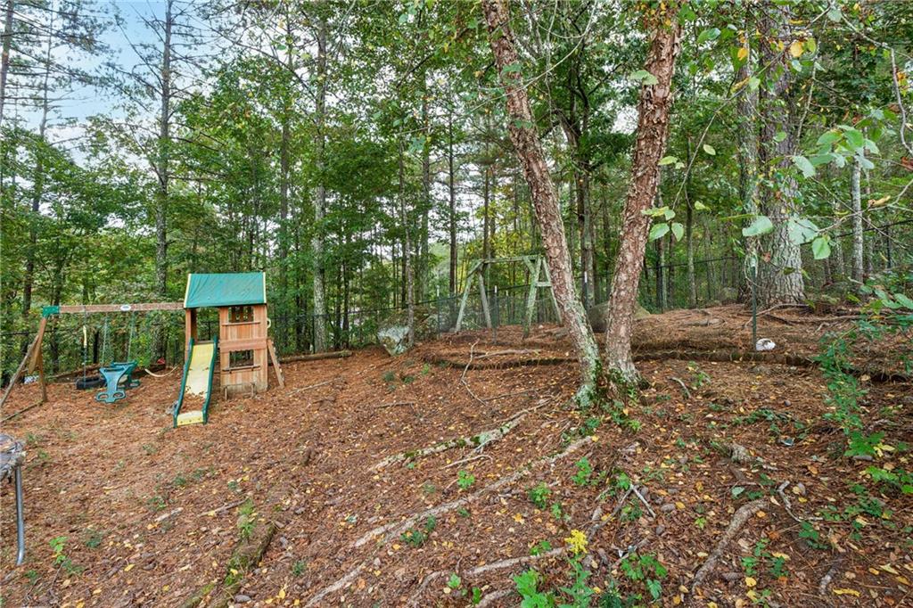 38 Mountain Ridge Road Northeast White, GA 30184 - Photo 70 of 79 a view of a park with large trees and wooden fence