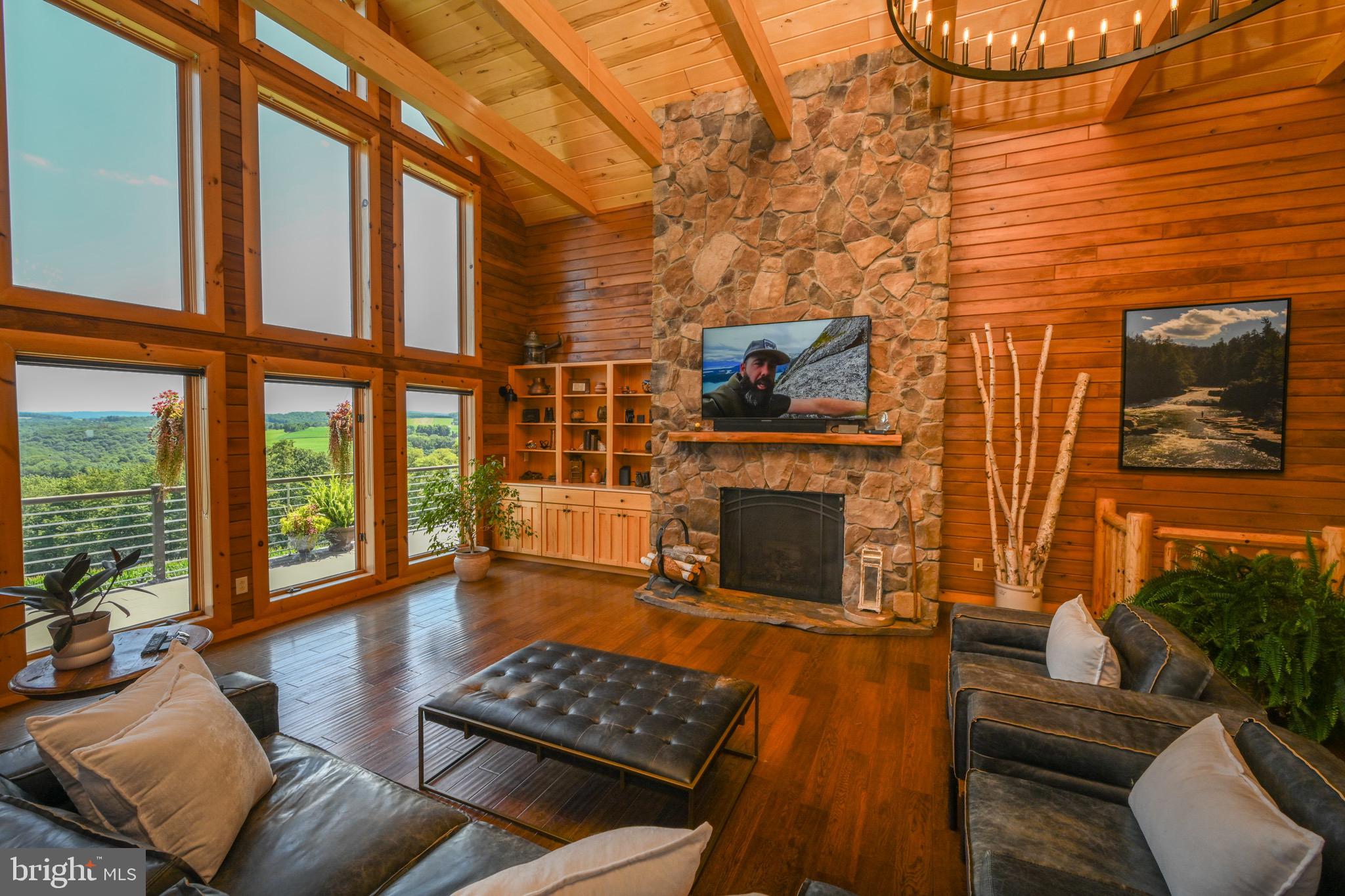 2325 Accident Friendsville Road Accident, MD 21520 - Photo 15 of 107 a living room with furniture a fireplace and a floor to ceiling window