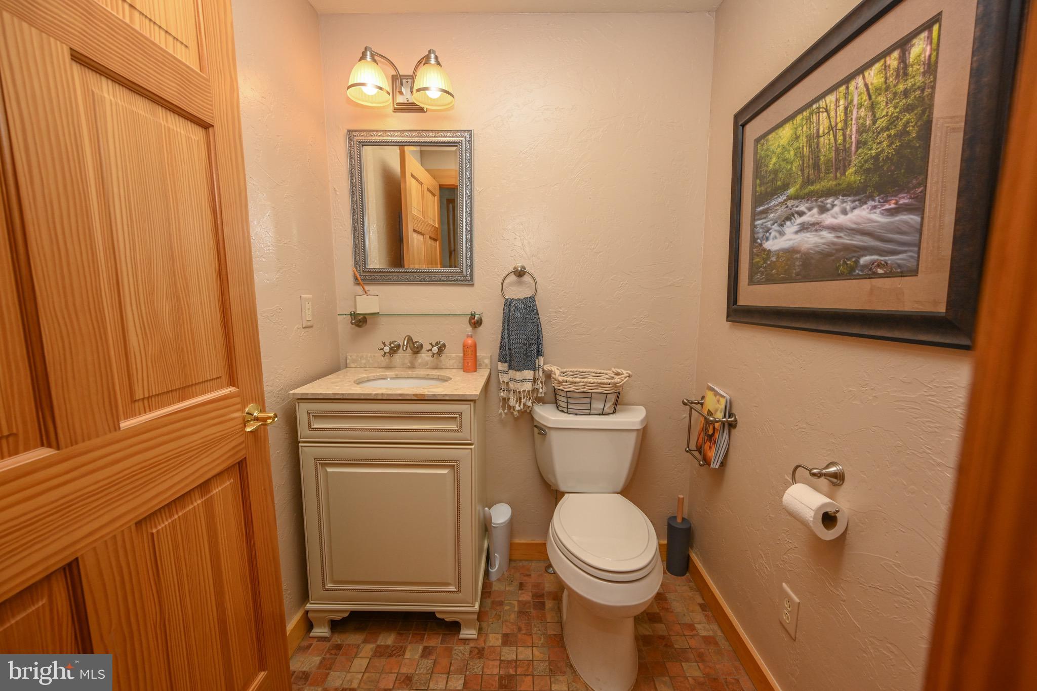 2325 Accident Friendsville Road Accident, MD 21520 - Photo 20 of 107 a bathroom with a toilet sink and mirror