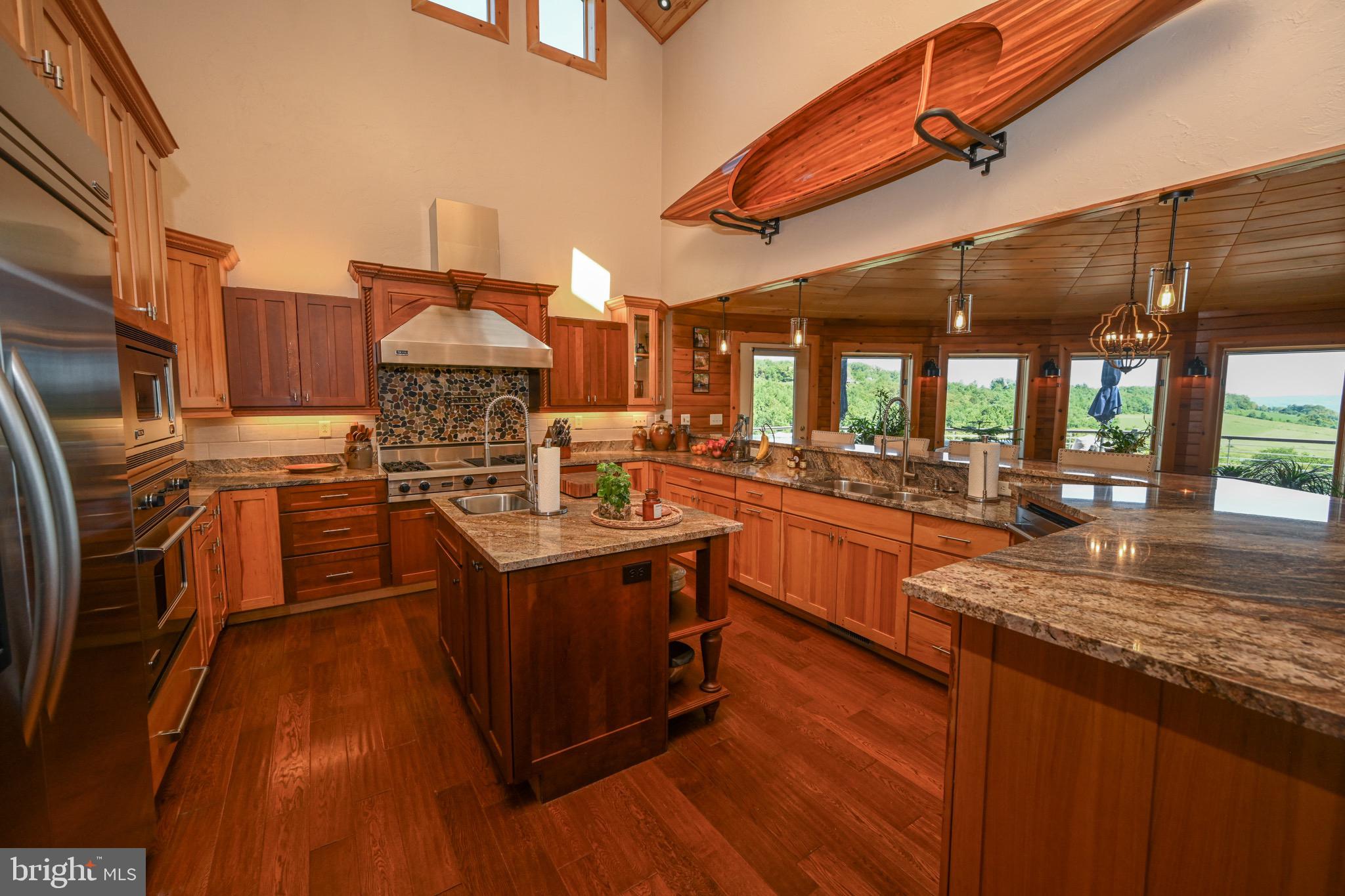 2325 Accident Friendsville Road Accident, MD 21520 - Photo 36 of 107 a kitchen with stainless steel appliances granite countertop a stove a sink and a refrigerator