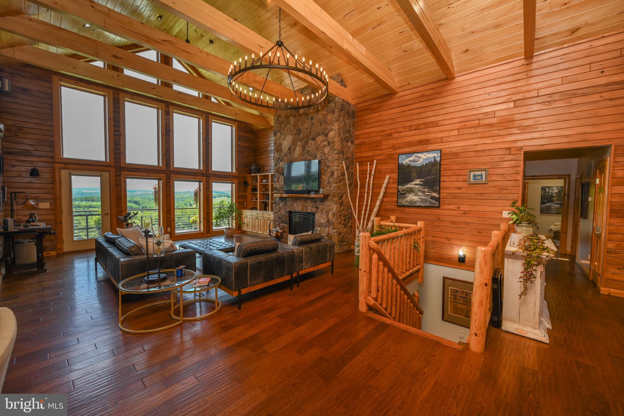 2325 Accident Friendsville Road Accident, MD 21520 - Photo 43 of 107 a living room with furniture floor to ceiling window and wooden floor