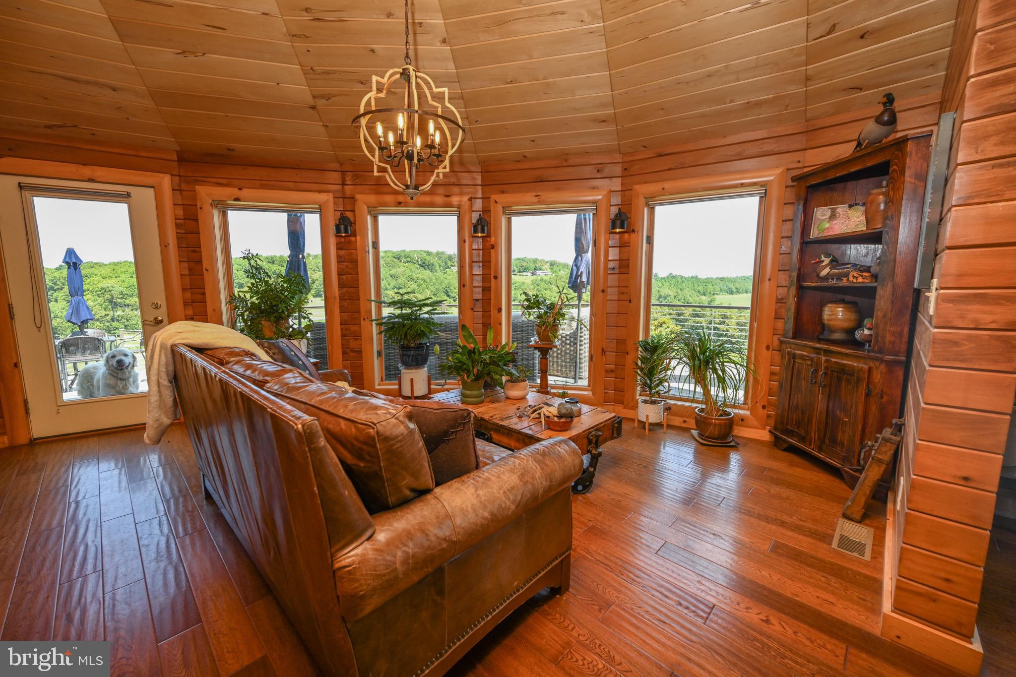 2325 Accident Friendsville Road Accident, MD 21520 - Photo 44 of 107 a living room with furniture and a floor to ceiling window