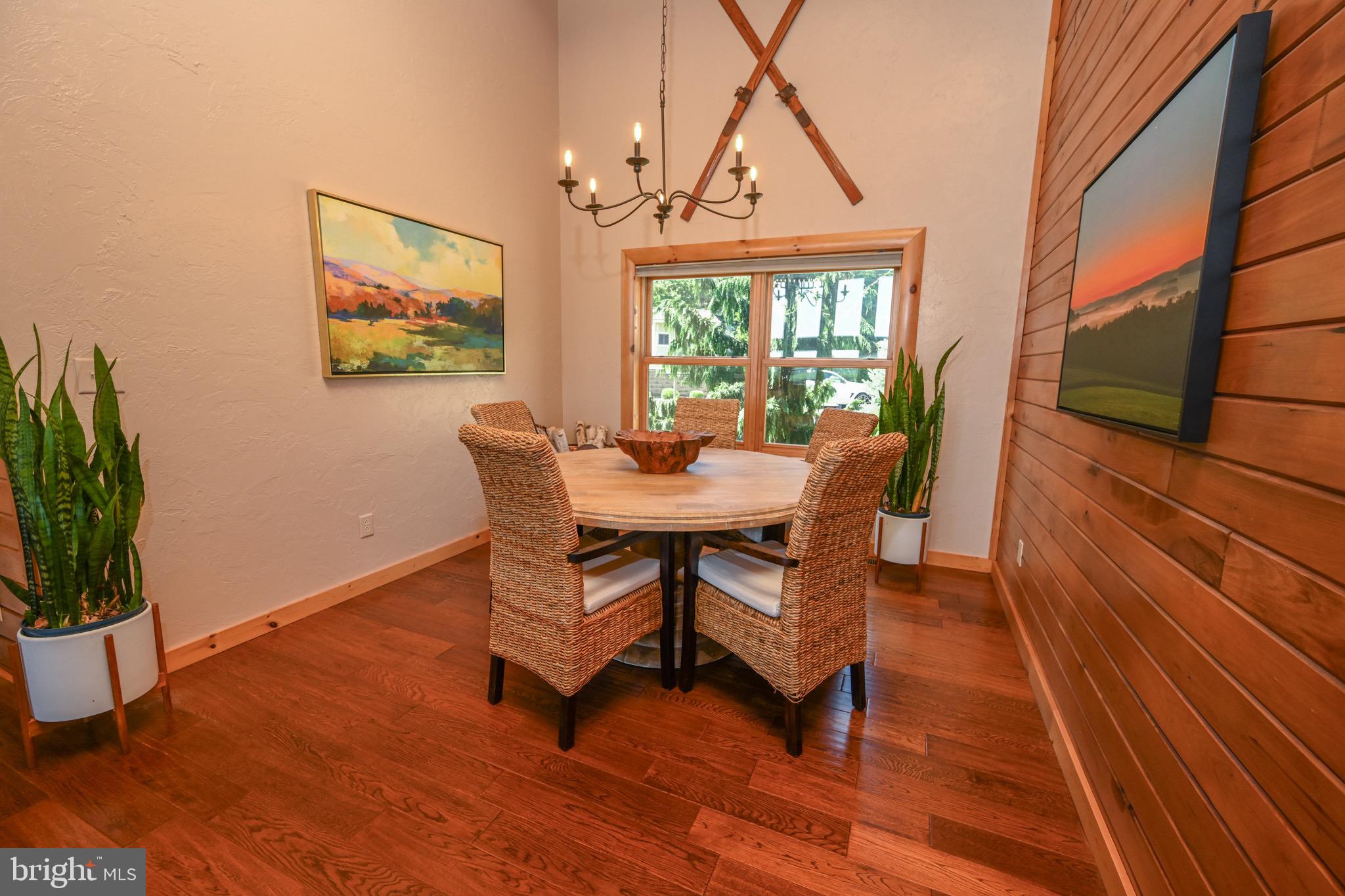 2325 Accident Friendsville Road Accident, MD 21520 - Photo 52 of 107 a dining room with furniture potted plants and wooden floor