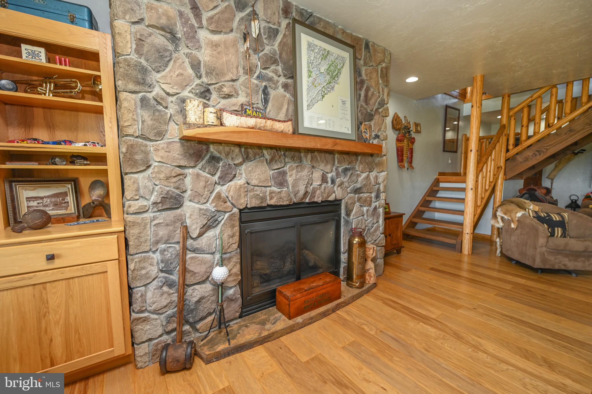 2325 Accident Friendsville Road Accident, MD 21520 - Photo 64 of 107 a living room with wooden floor and a fireplace