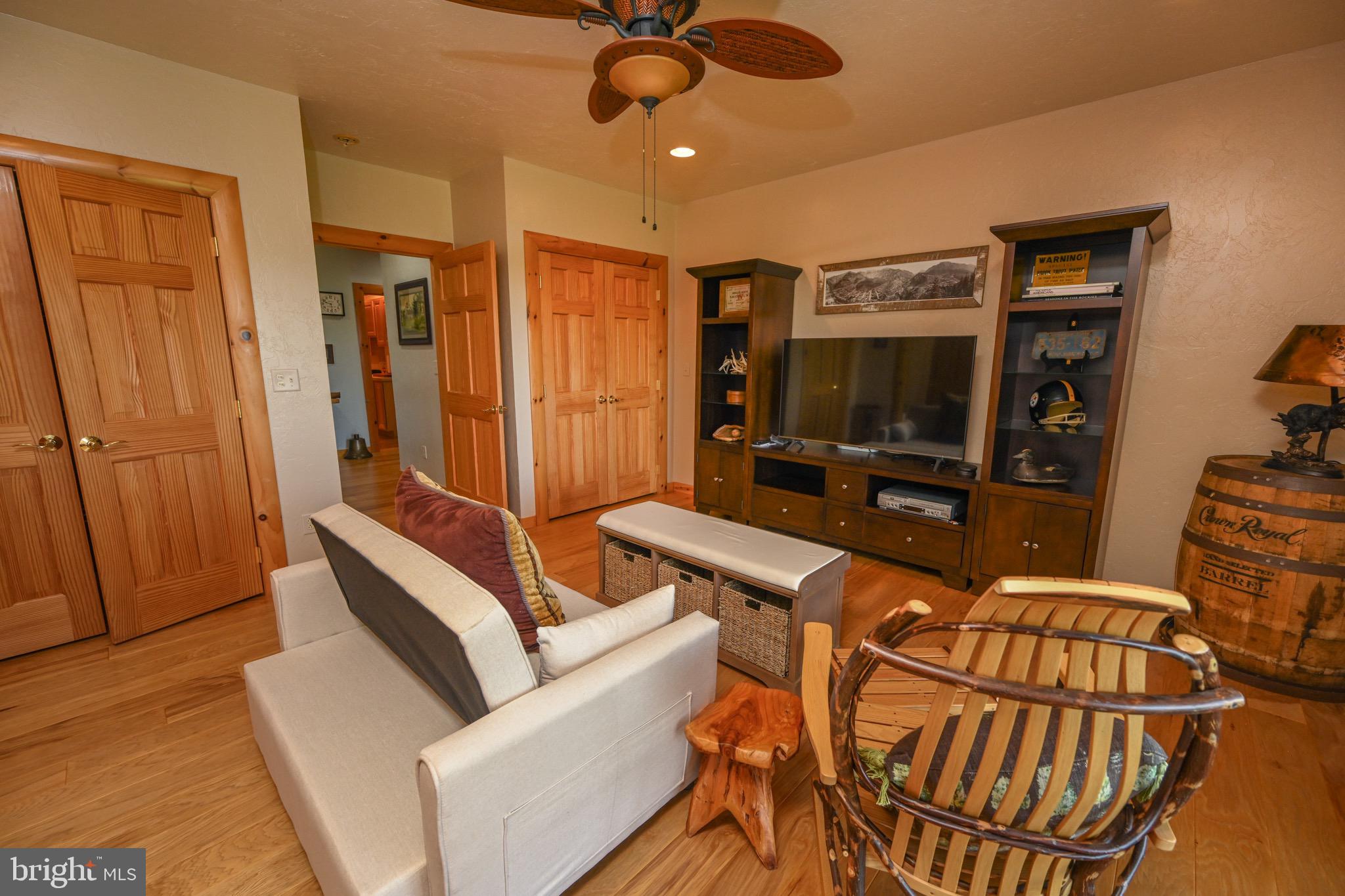 2325 Accident Friendsville Road Accident, MD 21520 - Photo 69 of 107 a living room with furniture a flat screen tv and a table