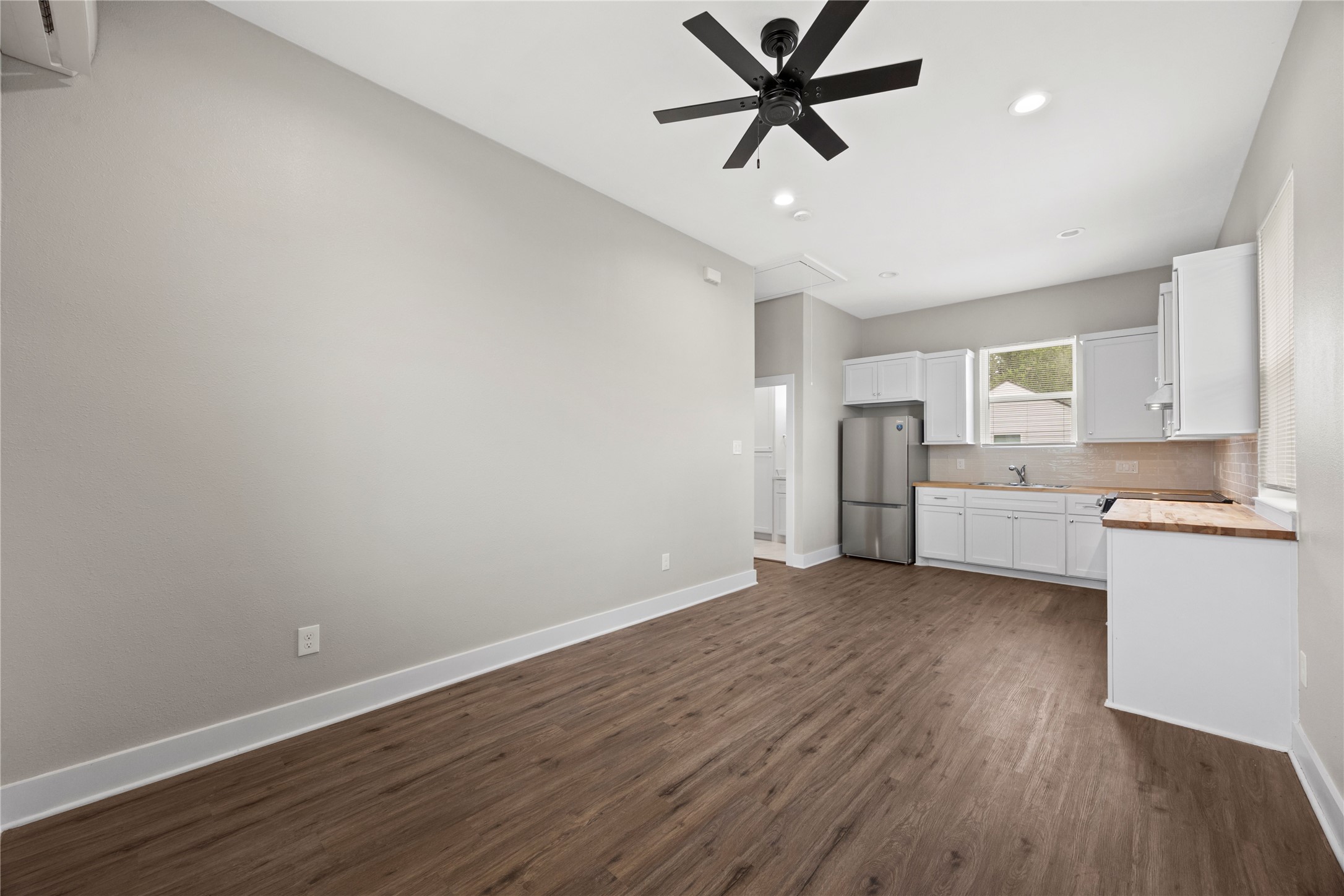 4384 Fiesta Lane Houston, TX 77004 - Photo 2 of 11 a view of a kitchen with a sink and dishwasher a refrigerator with wooden floor