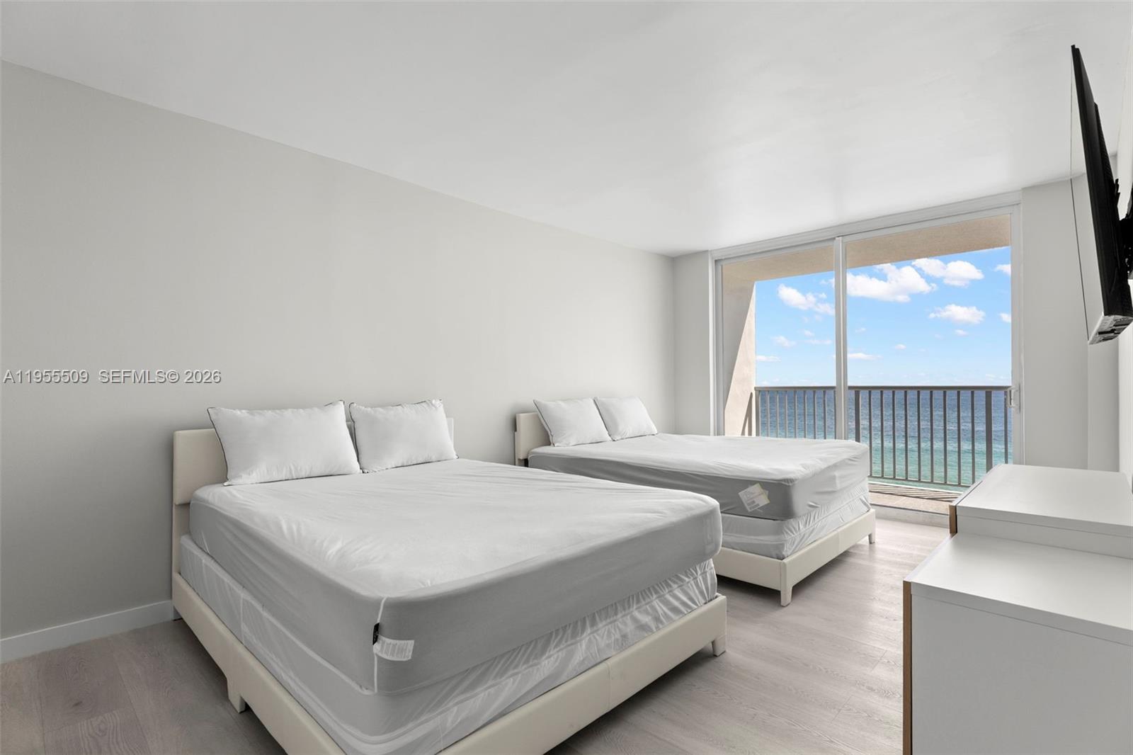 400 North Surf Road, Unit 903 Hollywood, FL 33019 - Photo 19 of 36 a bedroom with bed and a large window