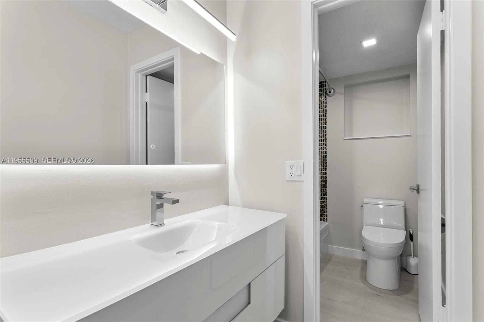 400 North Surf Road, Unit 903 Hollywood, FL 33019 - Photo 22 of 36 a bathroom with a toilet sink and mirror