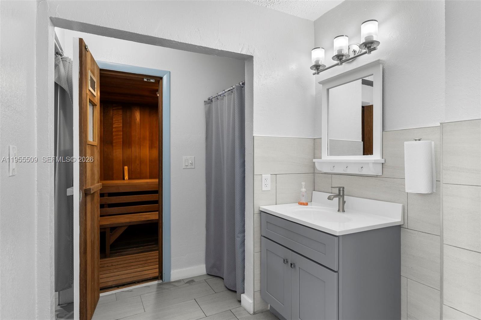 400 North Surf Road, Unit 903 Hollywood, FL 33019 - Photo 28 of 36 a bathroom with a sink and a mirror