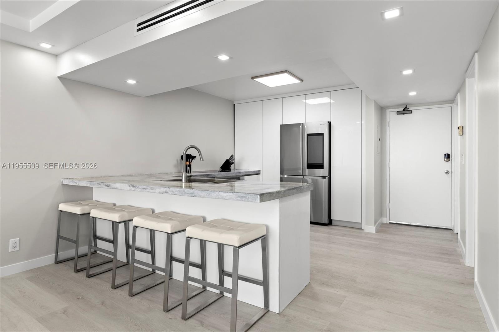 400 North Surf Road, Unit 903 Hollywood, FL 33019 - Photo 7 of 36 a kitchen with kitchen island a sink stove and refrigerator