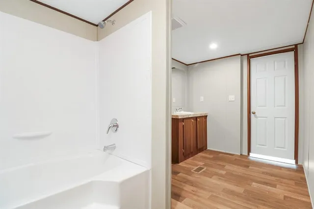 a bathroom with a bathtub and a shower