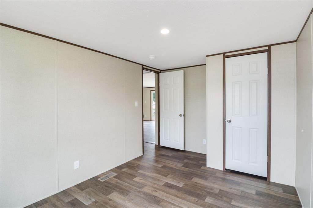 708 West 8th Street Coleman, TX 76834 - Photo 19 of 25 a view of empty room with wooden floor
