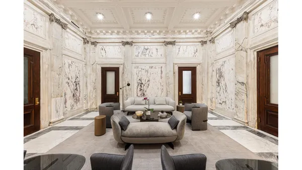 a living room with furniture and a clock
