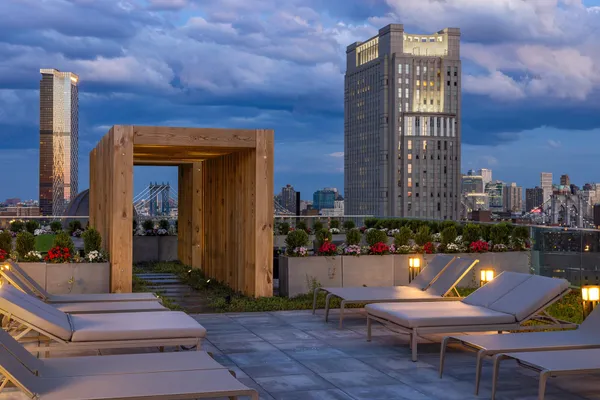 a view of a patio with couches and city view