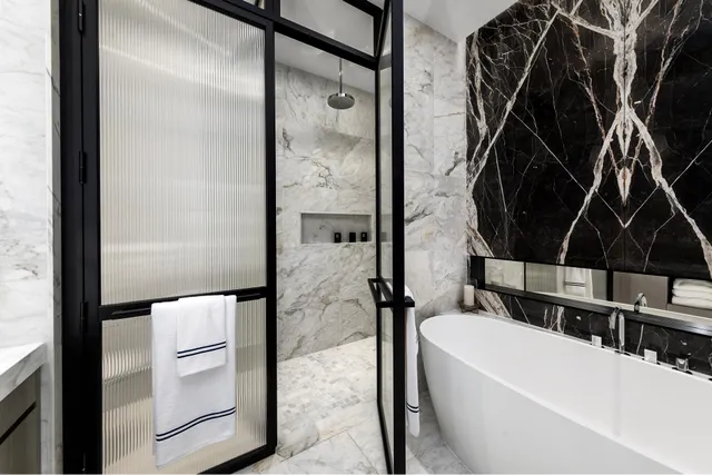 a bedroom with a bed and windows