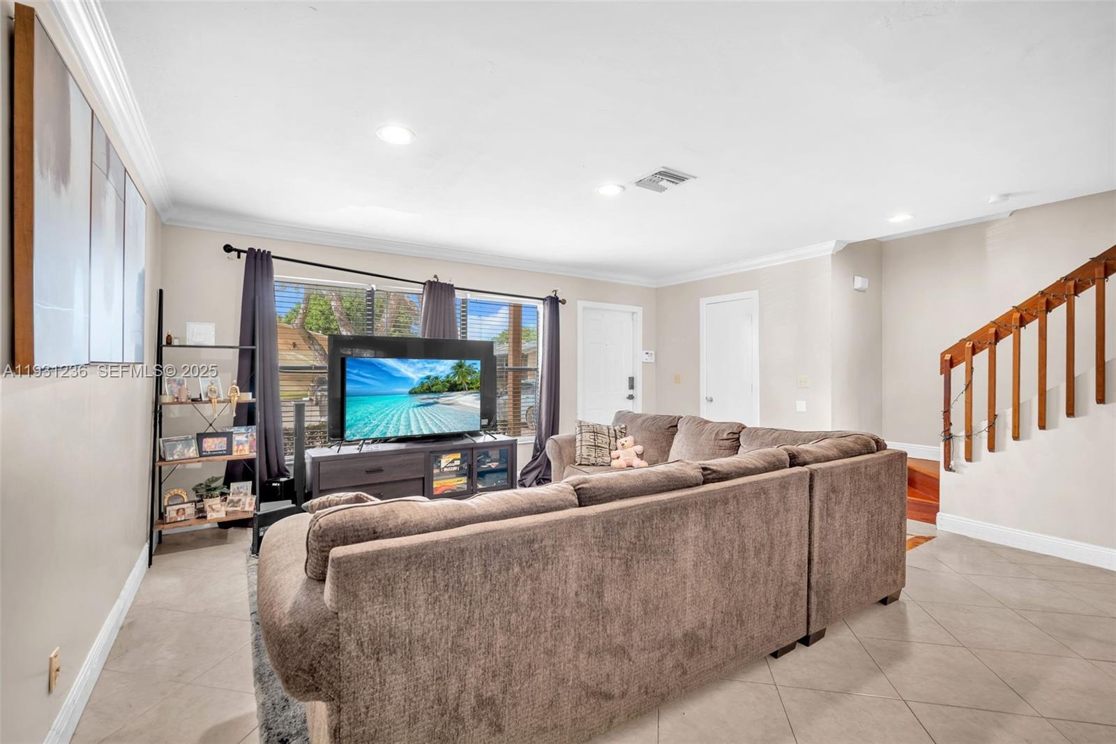 3370 Beau Rivage Drive, Unit 3N Pompano Beach, FL 33064 - Photo 12 of 38 a living room with furniture and a flat screen tv