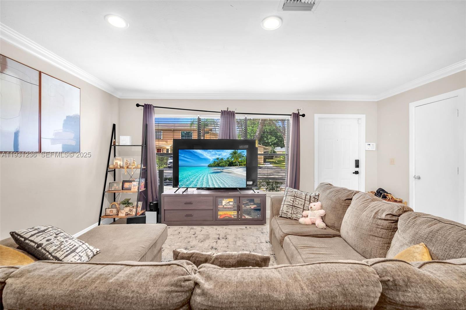 3370 Beau Rivage Drive, Unit 3N Pompano Beach, FL 33064 - Photo 13 of 38 a living room with furniture and a flat screen tv