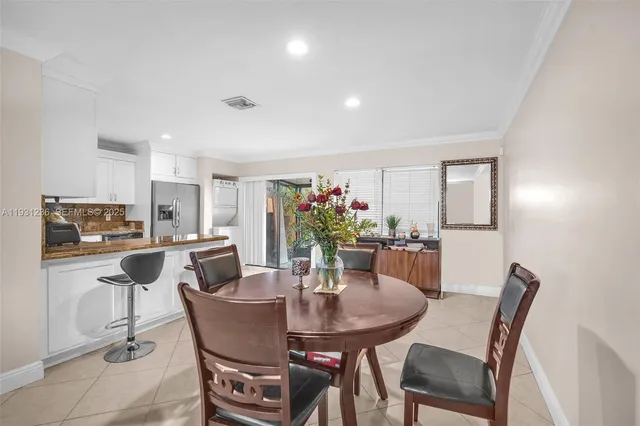 a view of a dining room with furniture and a potted plant