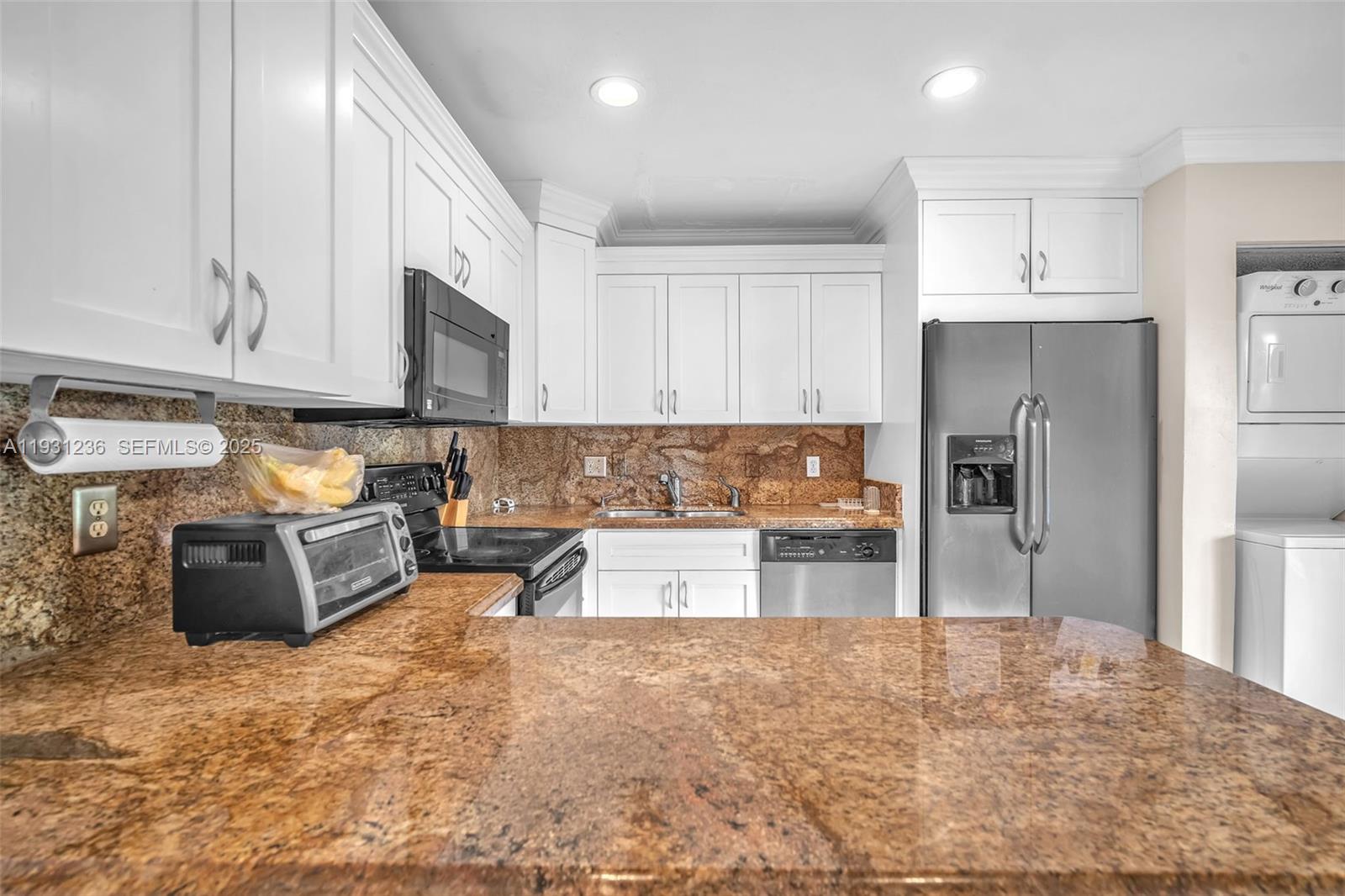 3370 Beau Rivage Drive, Unit 3N Pompano Beach, FL 33064 - Photo 19 of 38 a large kitchen with stainless steel appliances granite countertop a refrigerator sink and cabinets