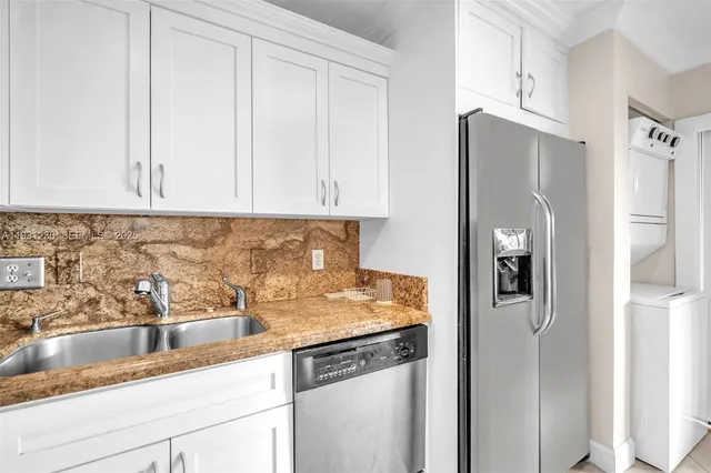 a kitchen with stainless steel appliances granite countertop refrigerator sink and cabinets