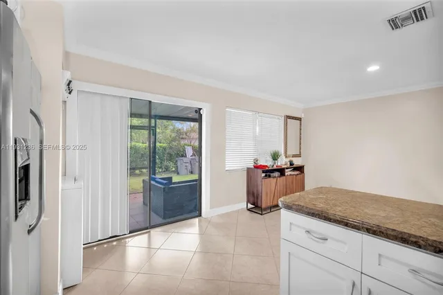 a kitchen with stainless steel appliances granite countertop a refrigerator and a sink