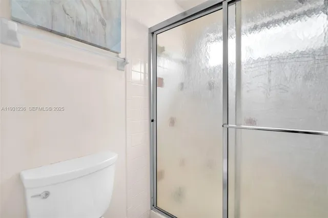 a bathroom with a glass shower door