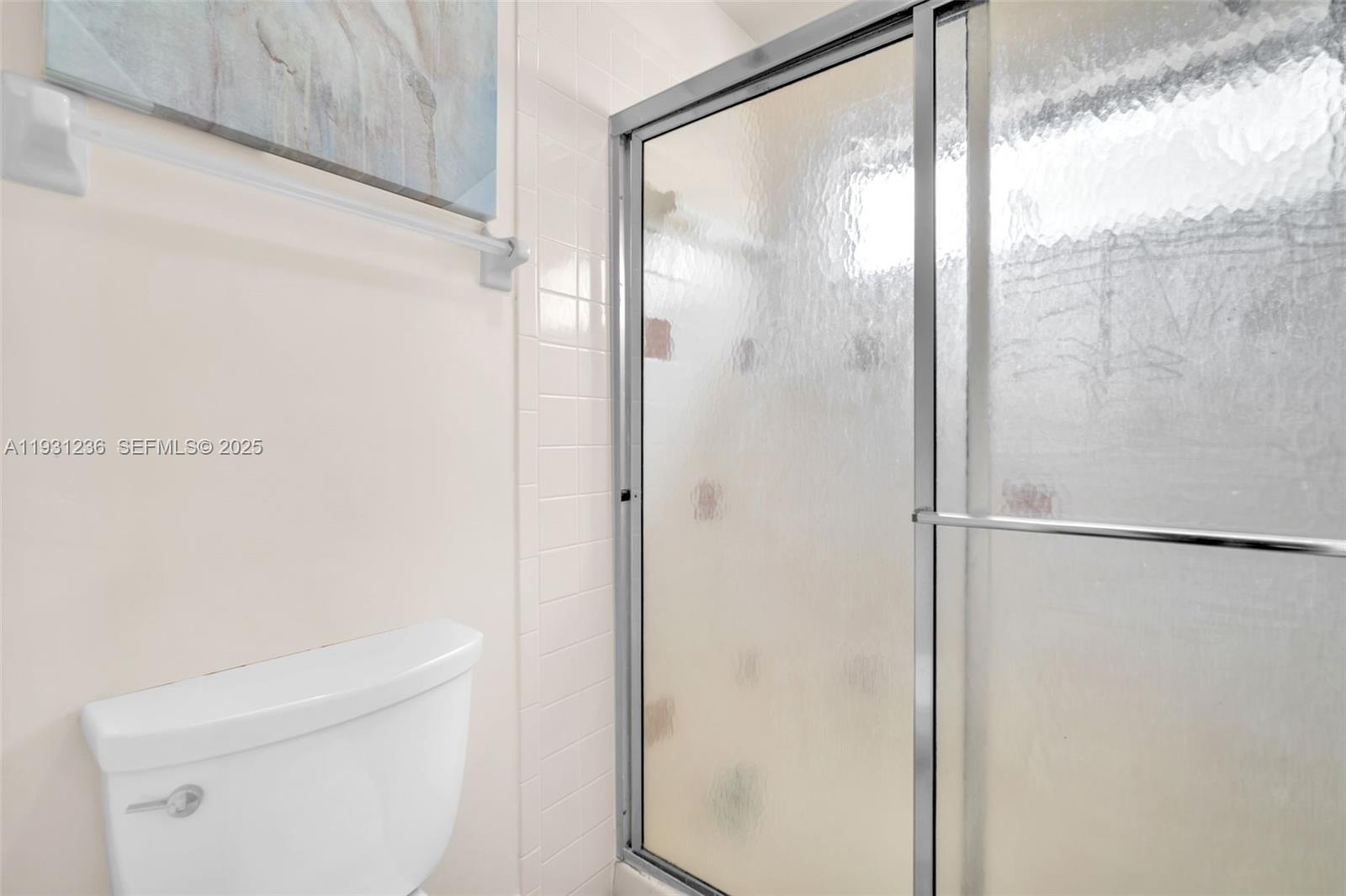 3370 Beau Rivage Drive, Unit 3N Pompano Beach, FL 33064 - Photo 31 of 38 a bathroom with a glass shower door