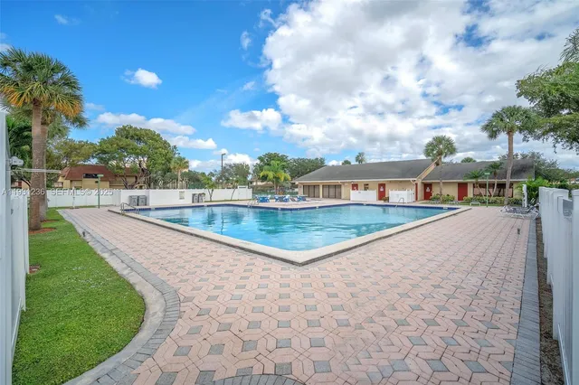 a view of a swimming pool with a yard