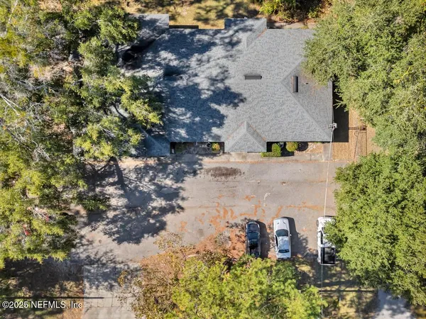 an aerial view of a house with a yard