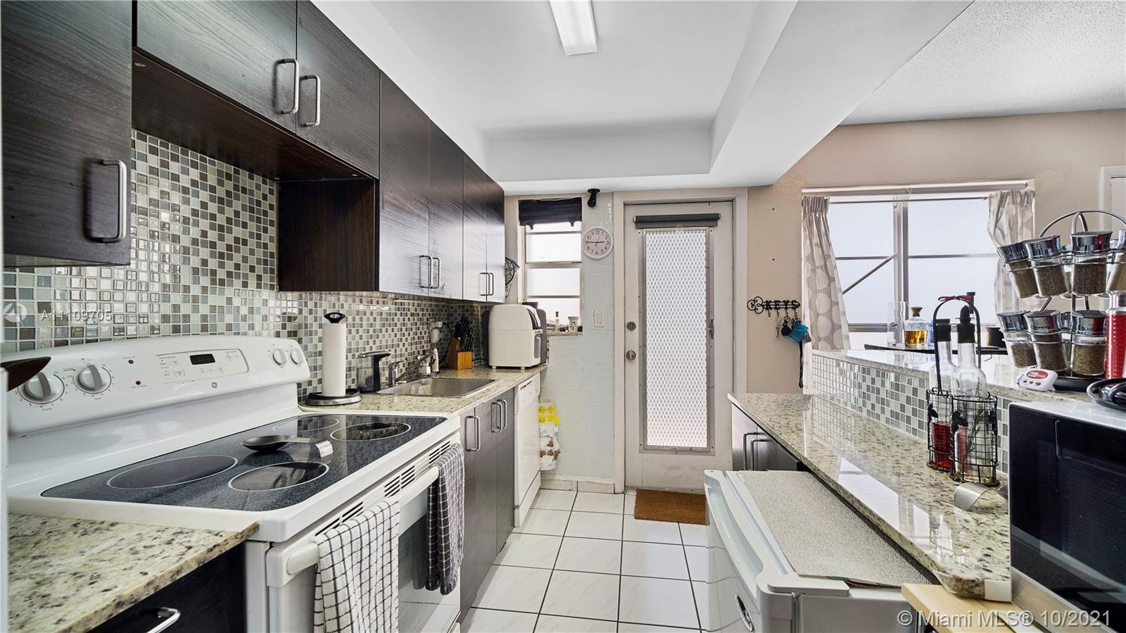 1340 Lincoln Road, Unit 806 Miami Beach, FL 33139 - Photo 11 of 48 a kitchen with a stove sink and a refrigerator