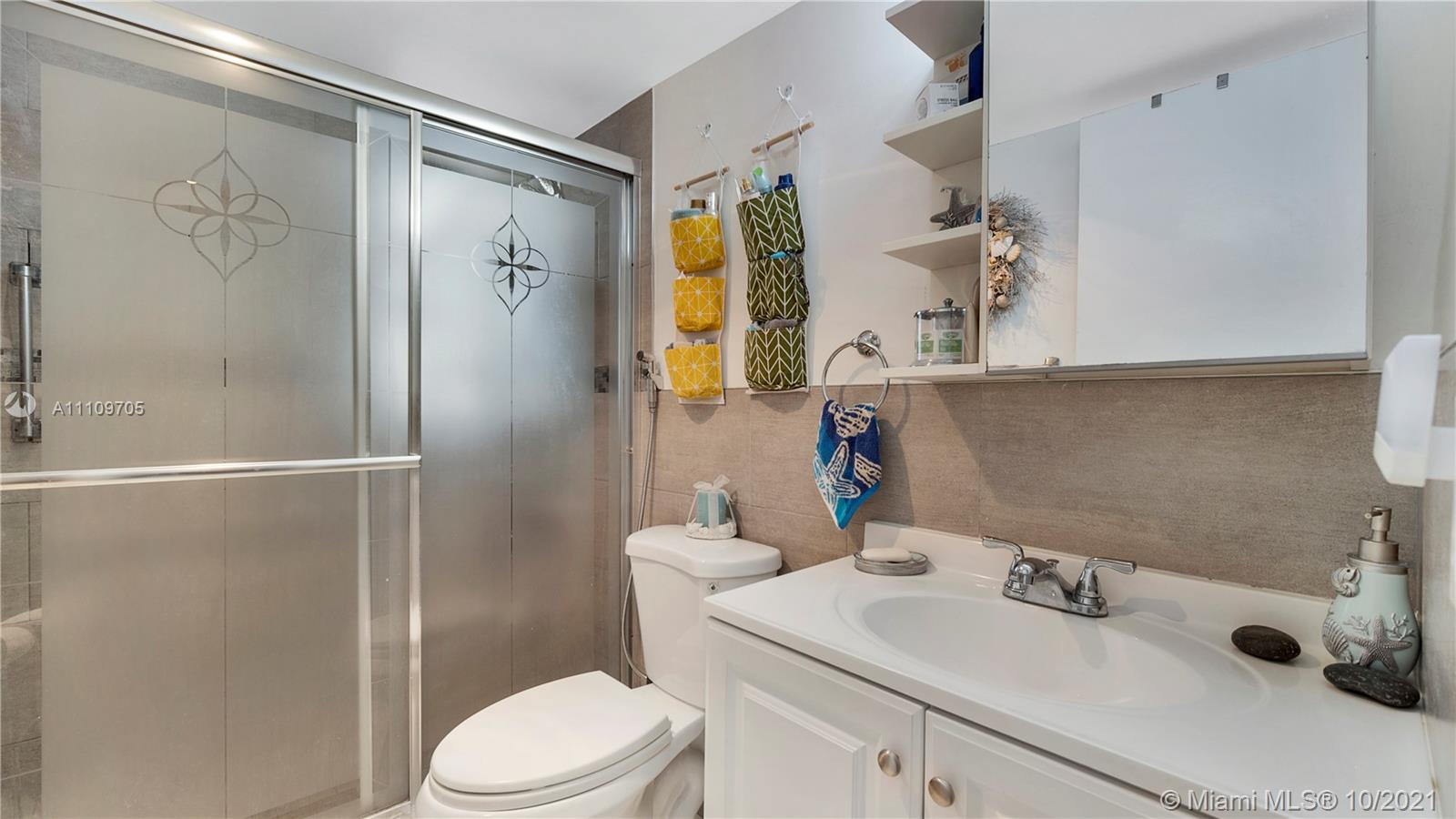1340 Lincoln Road, Unit 806 Miami Beach, FL 33139 - Photo 16 of 48 a bathroom with a sink toilet and shower