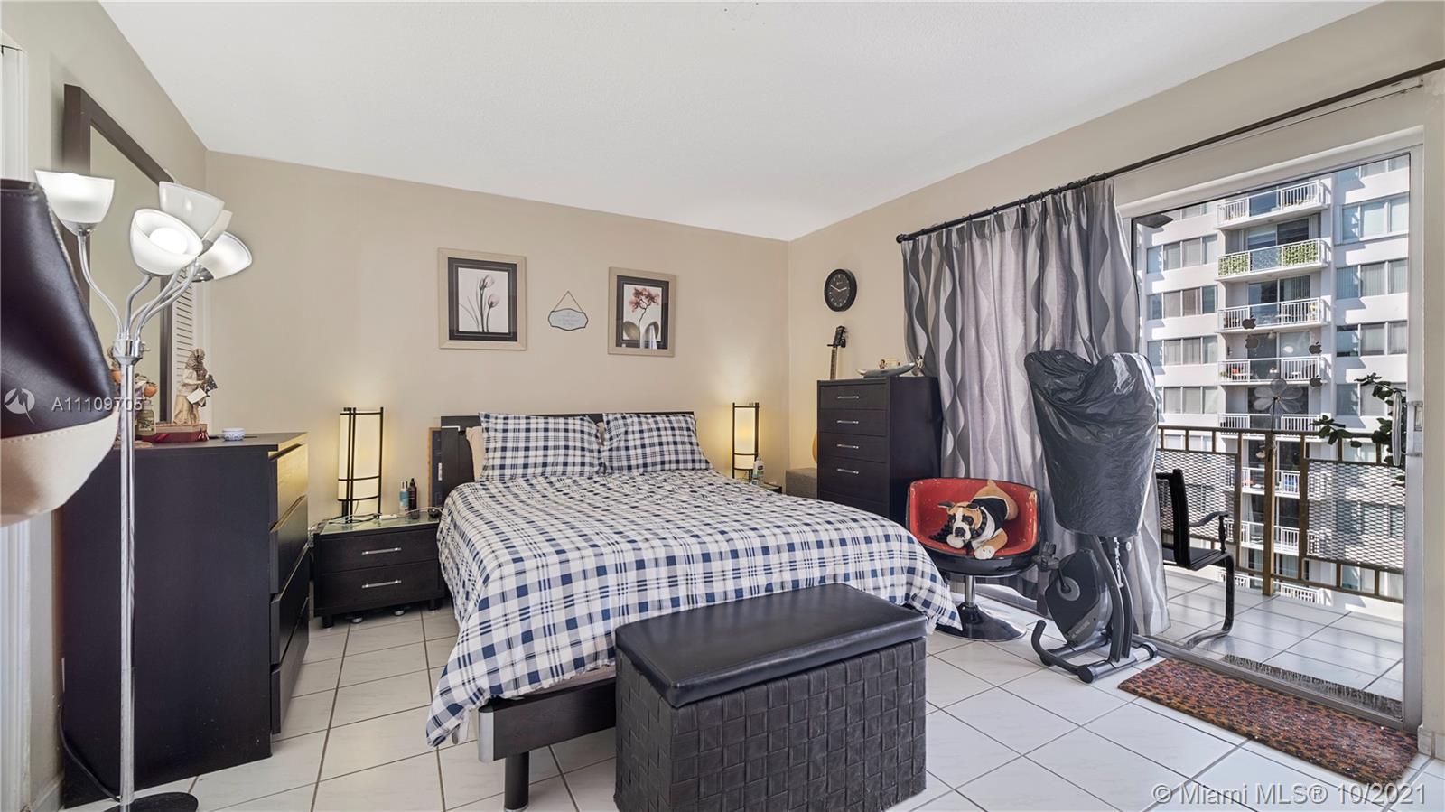 1340 Lincoln Road, Unit 806 Miami Beach, FL 33139 - Photo 17 of 48 a bedroom with a bed and dresser with mirror