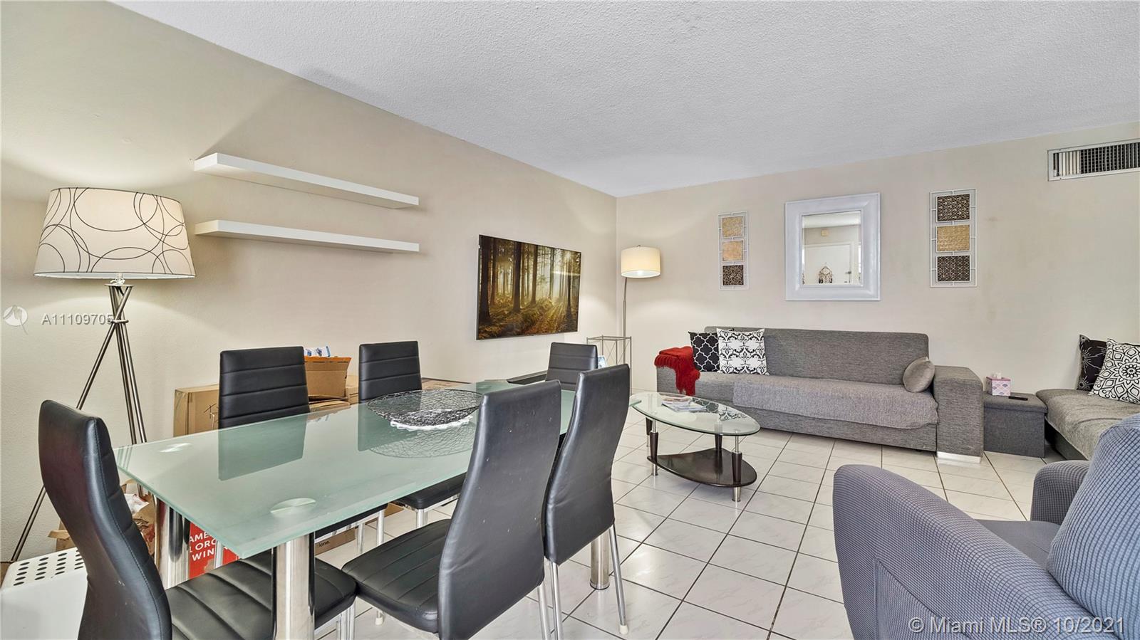 1340 Lincoln Road, Unit 806 Miami Beach, FL 33139 - Photo 4 of 48 a living room with furniture a lamp and a flat screen tv