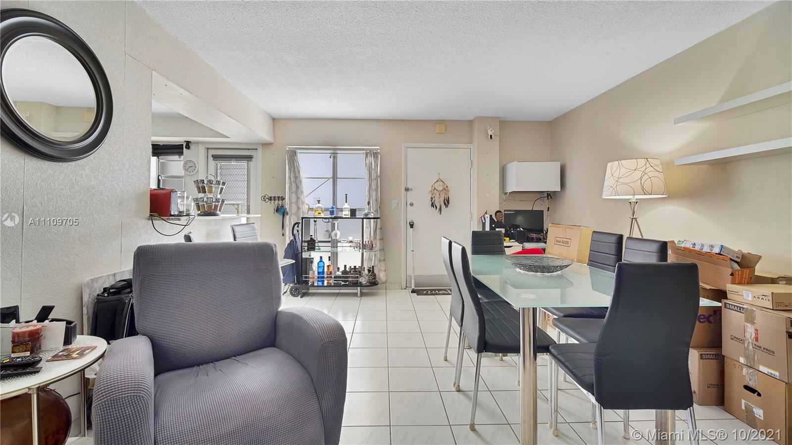 1340 Lincoln Road, Unit 806 Miami Beach, FL 33139 - Photo 5 of 48 a living room with furniture a window and a clock
