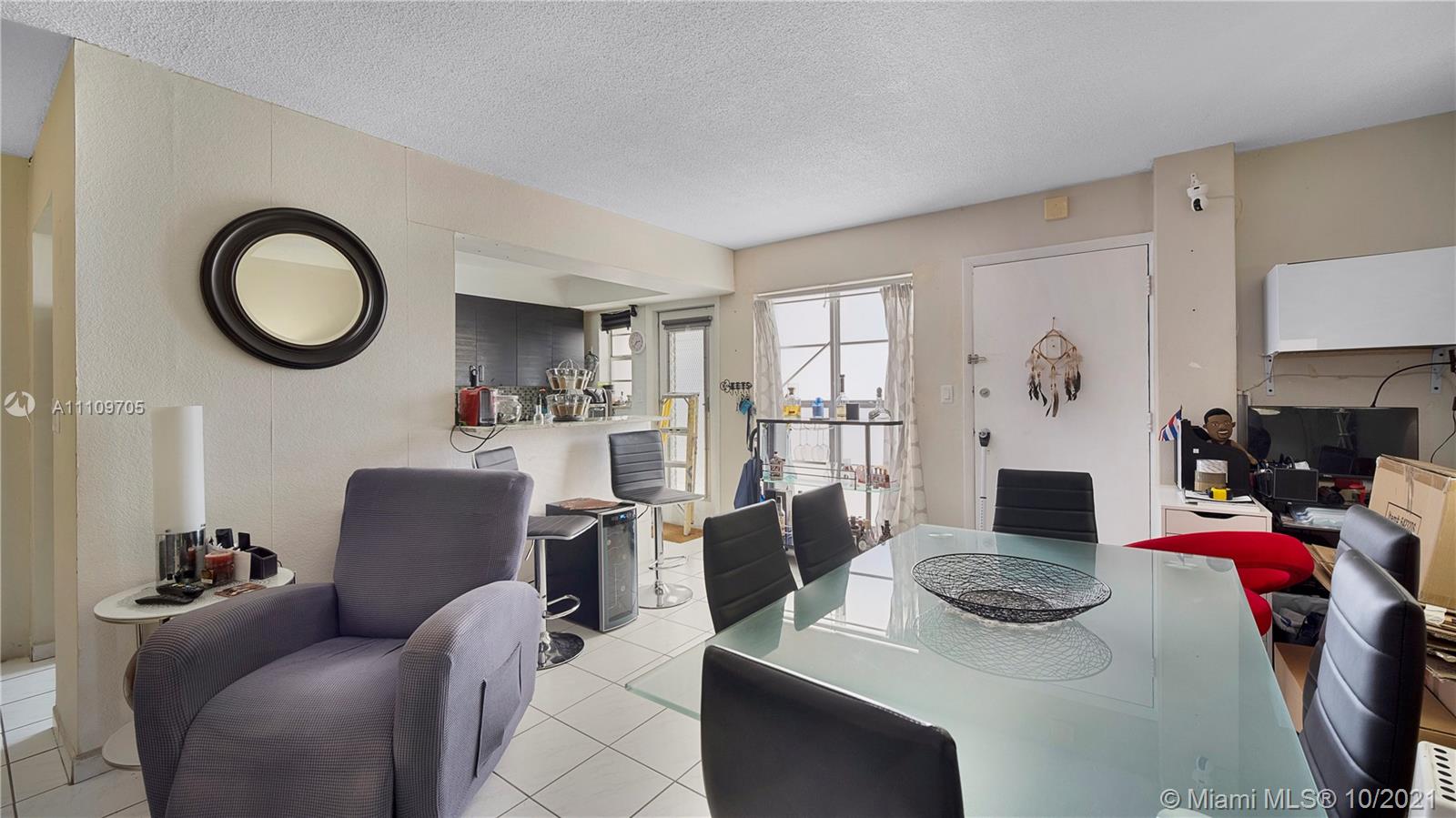 1340 Lincoln Road, Unit 806 Miami Beach, FL 33139 - Photo 6 of 48 a living room with furniture a fireplace and a window