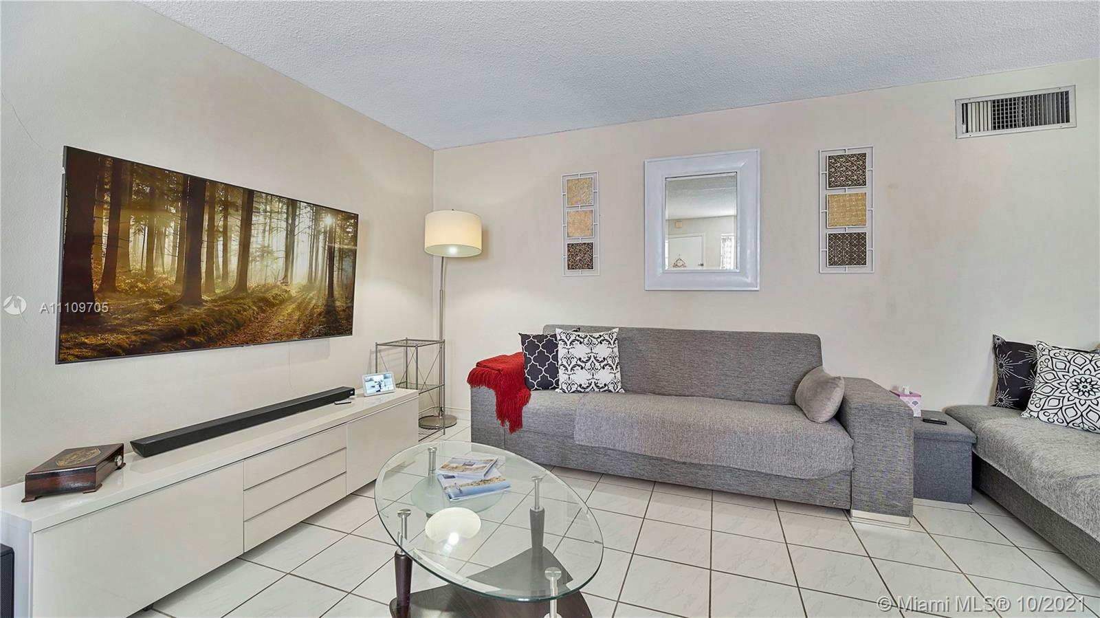 1340 Lincoln Road, Unit 806 Miami Beach, FL 33139 - Photo 7 of 48 a living room with furniture and a flat screen tv
