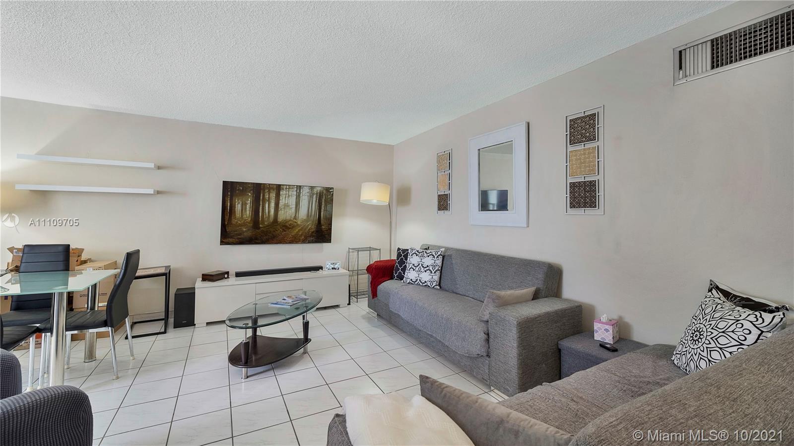 1340 Lincoln Road, Unit 806 Miami Beach, FL 33139 - Photo 9 of 48 a living room with furniture and a flat screen tv