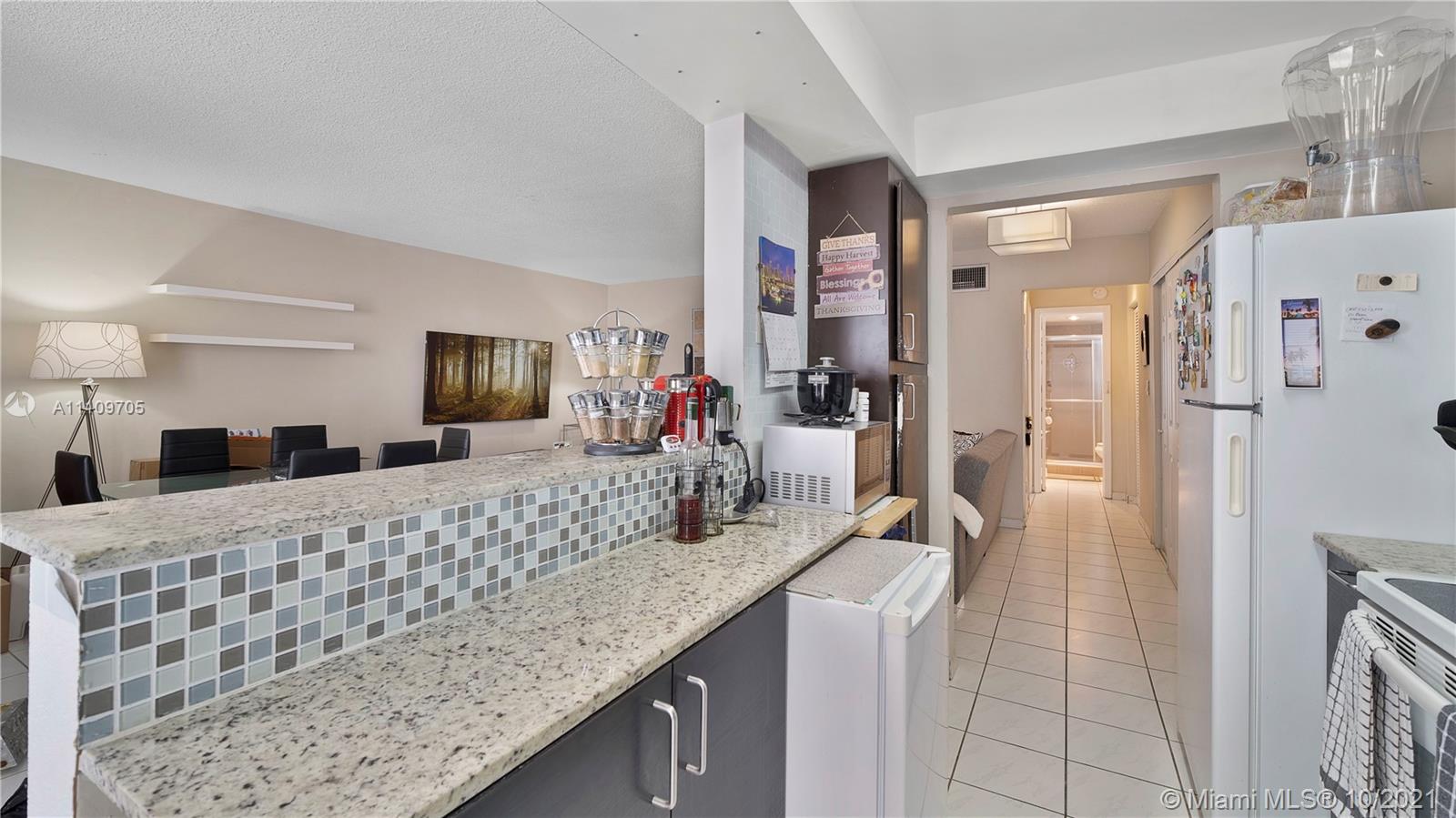 1340 Lincoln Road, Unit 806 Miami Beach, FL 33139 - Photo 10 of 48 a bathroom with a granite countertop sink a mirror and shower
