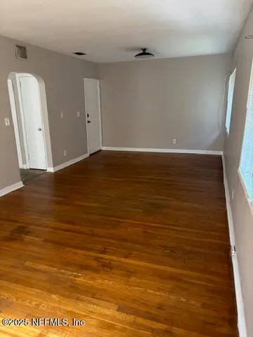 a view of room with wooden floor