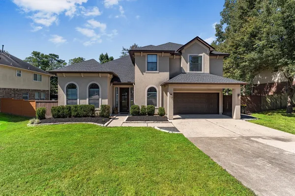 a front view of a house with a garden and yard