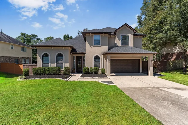 a front view of a house with a garden and yard