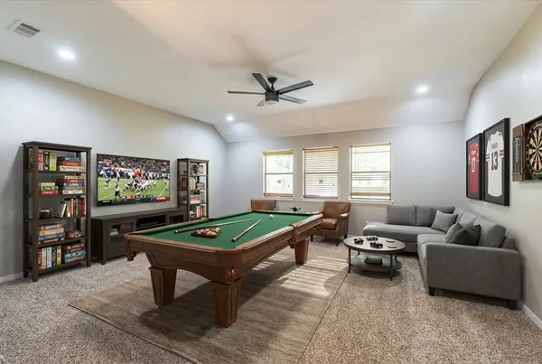 a living room with furniture a projector and a flat screen tv